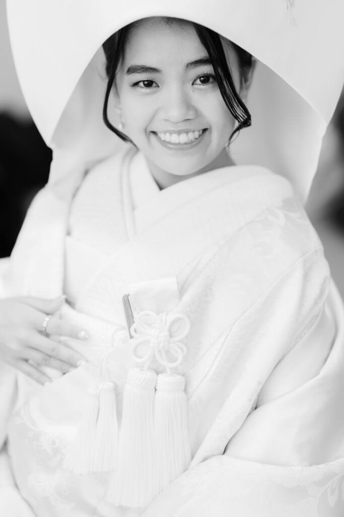 Elegant black-and-white portrait of the bride wearing traditional Japanese wedding attire.