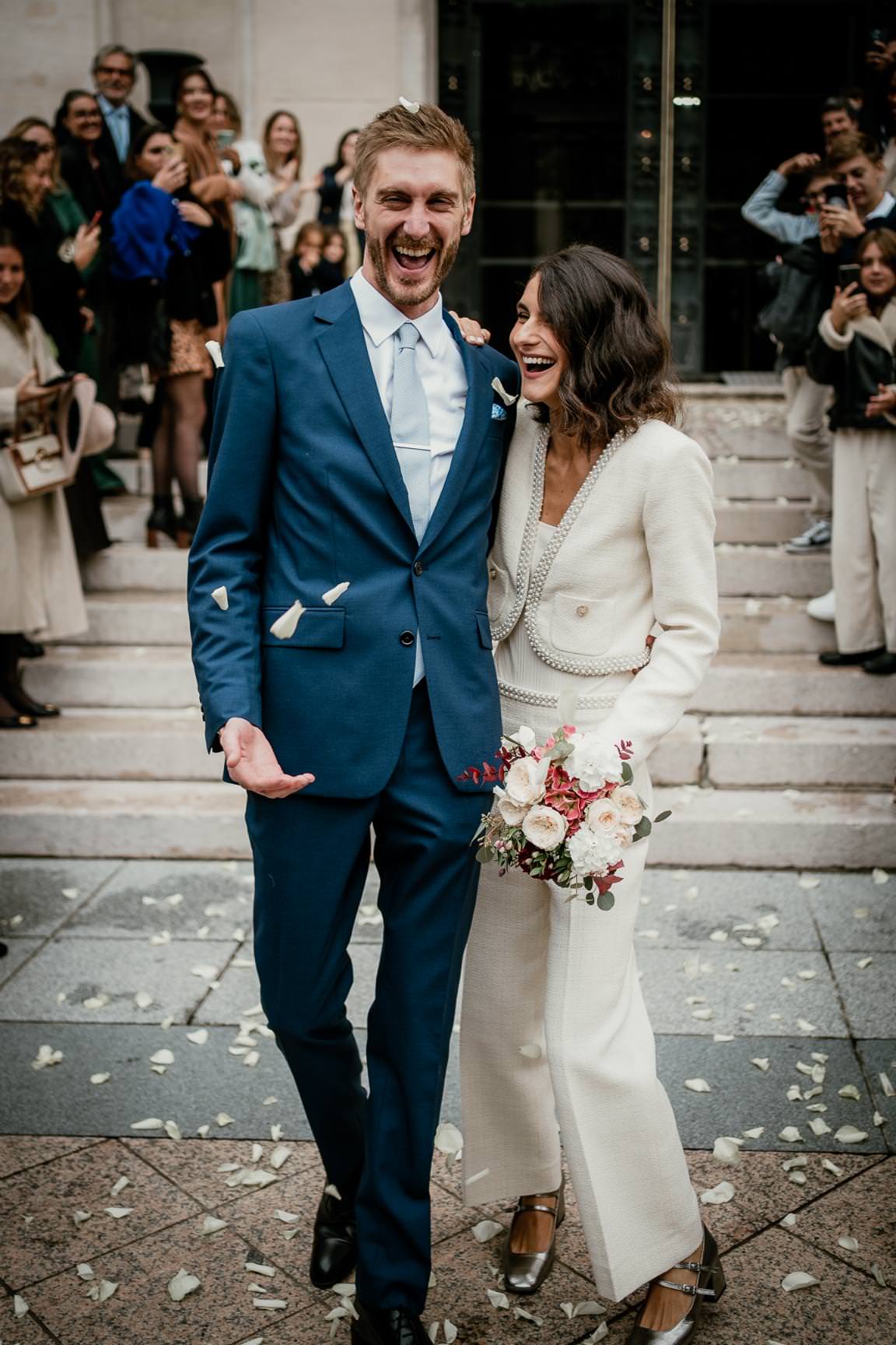 Elegant couple leaving a parisian city hall after their wedding ceremony.