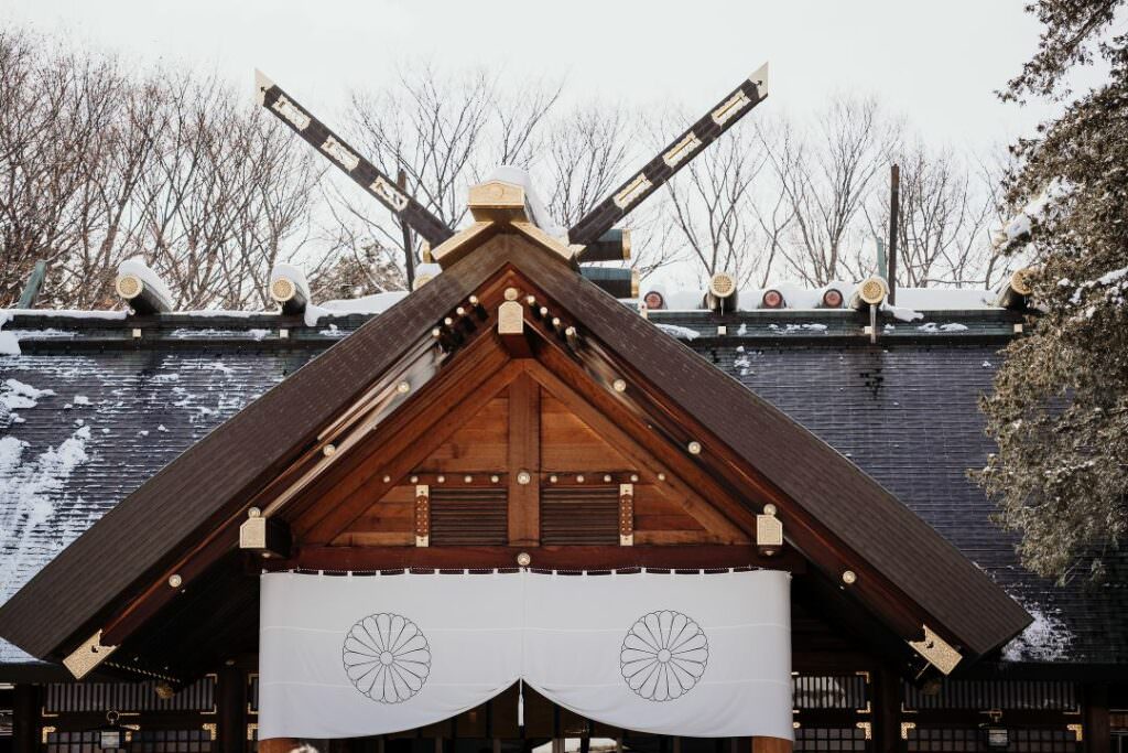 Winter view of Hokkaido Shrine’s wooden entrance and roof before a traditional Shinto wedding ceremony.