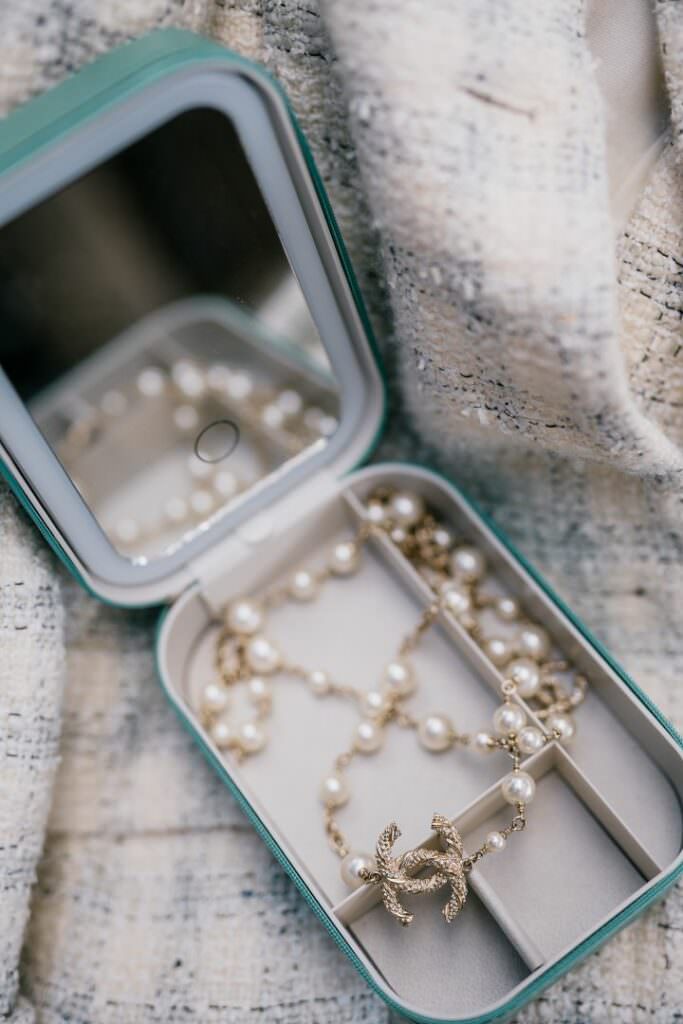 Elegant flatlay of fine pearl jewelry in a luxury box, captured in a refined editorial wedding style.