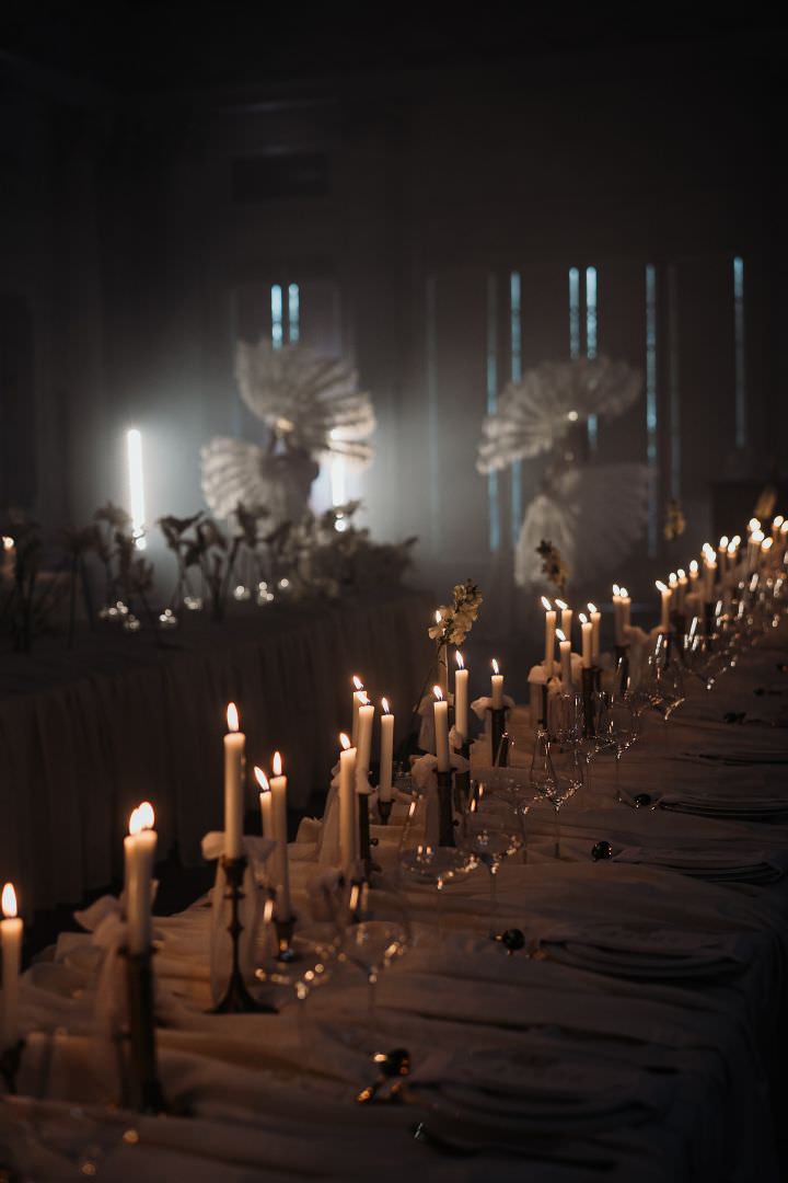Elegant candlelit wedding dinner setting, captured with a refined and atmospheric editorial aesthetic.