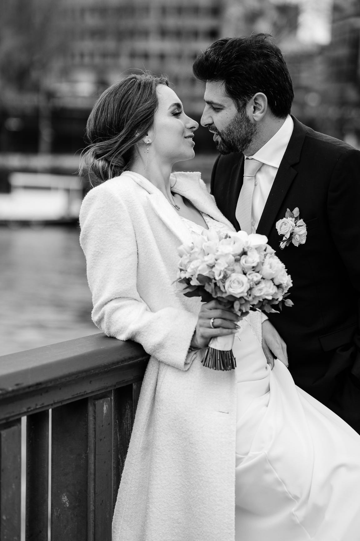 Black and white portrait of a couple on their Paris civil wedding by the Seine.