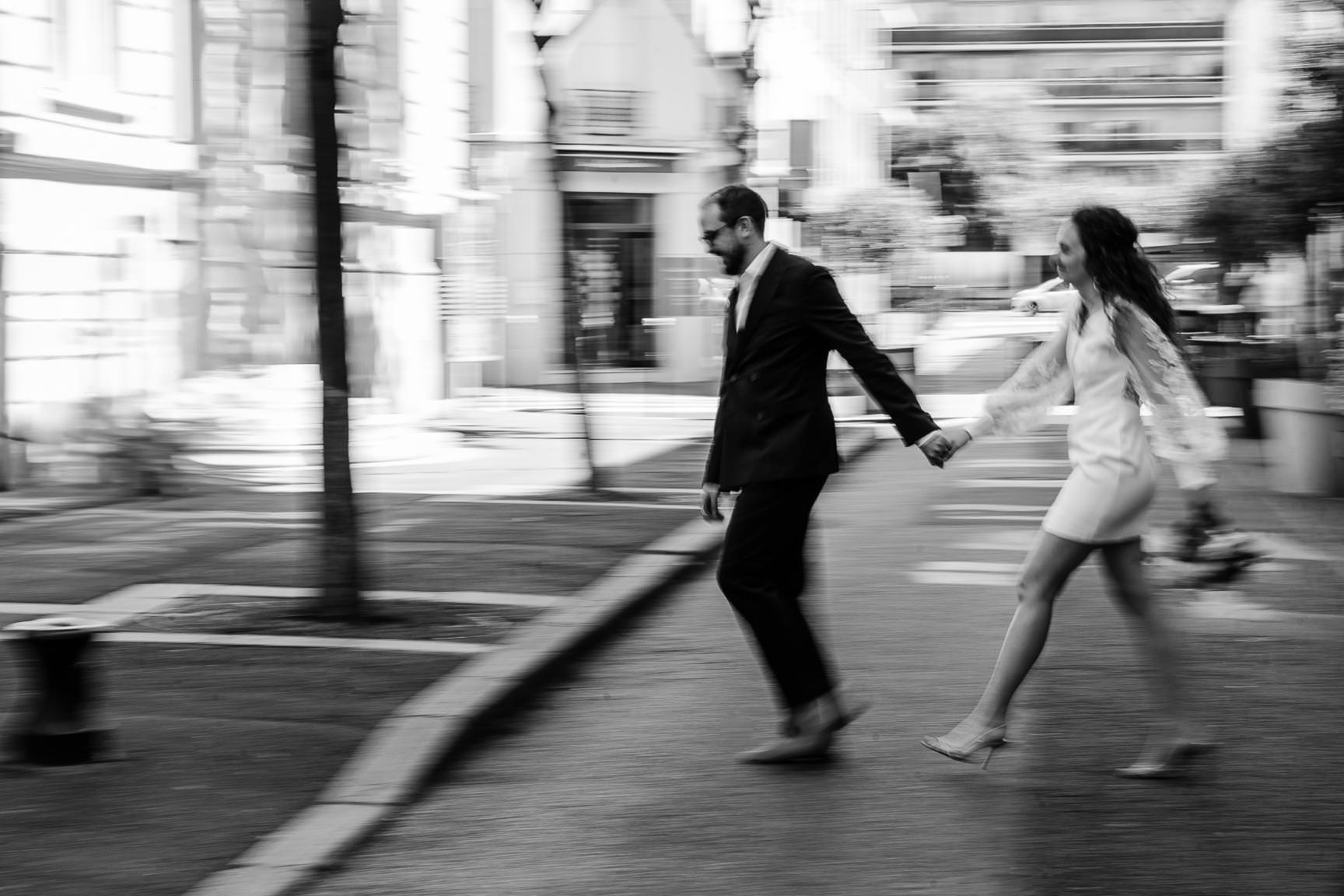 Paris civil wedding couple walking hand in hand through the streets of the city.