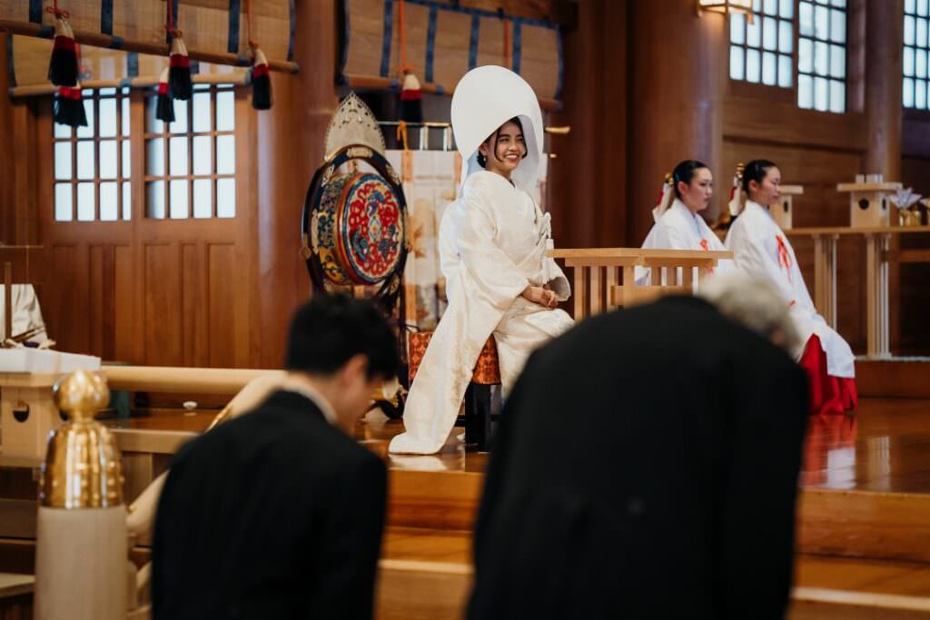 Refined Japanese bride seated inside the Shinto shrine during an elegant winter wedding ceremony in Hokkaido.