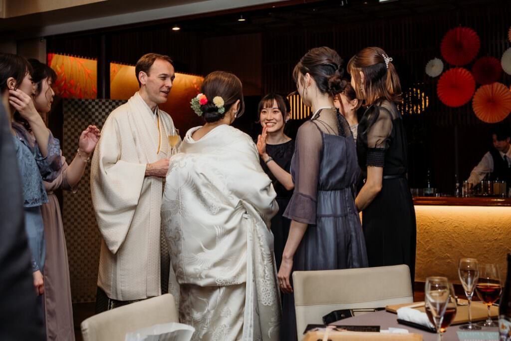 Refined wedding reception scene with guests and family sharing a moment during an elegant celebration in Hokkaido.