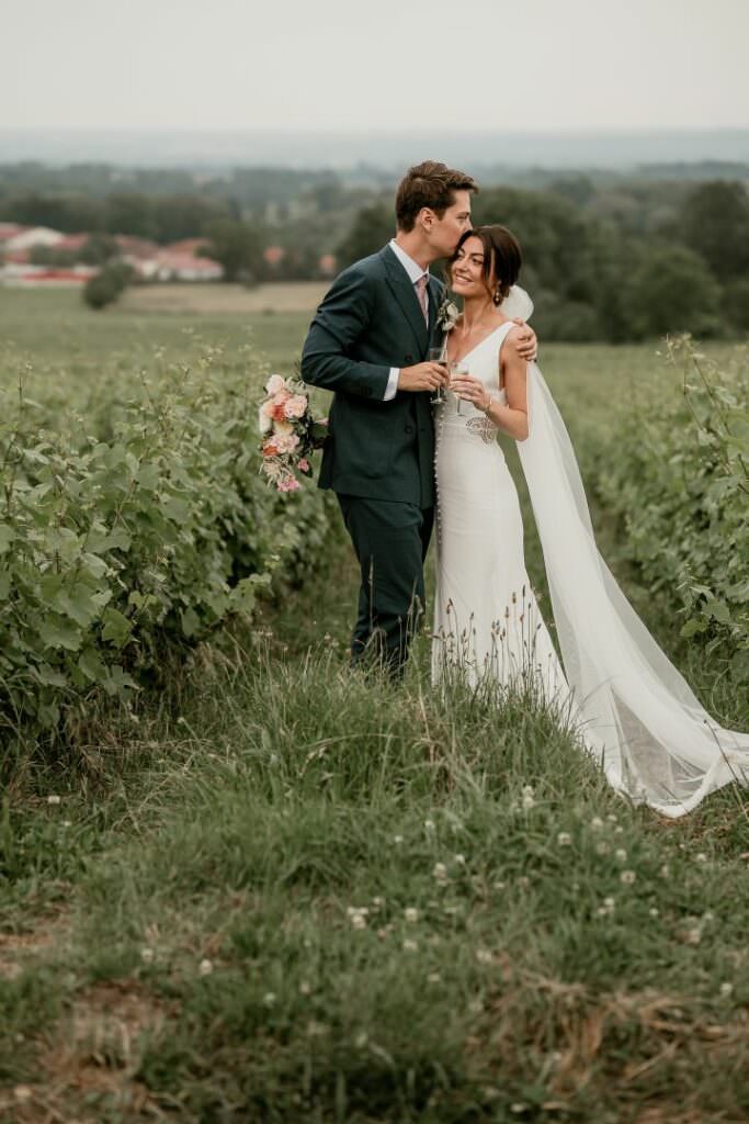 Romantic portrait of a wedding couple in a French vineyard, photographed with soft, refined elegance.