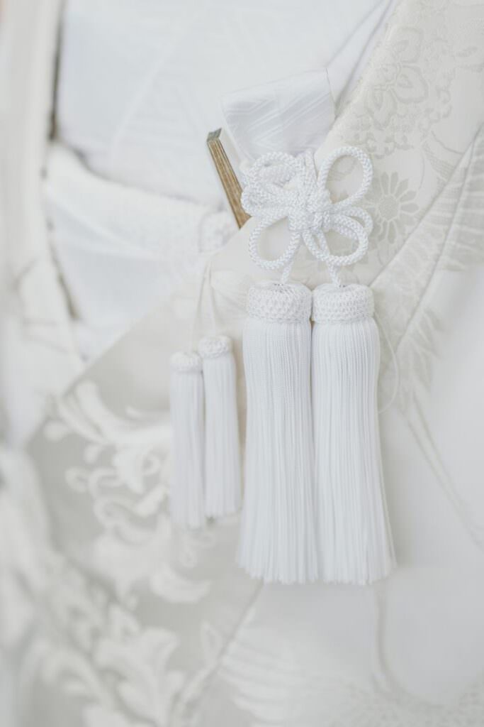 Close-up of tassels and embroidered details on the bride’s white shiromuku wedding kimono.