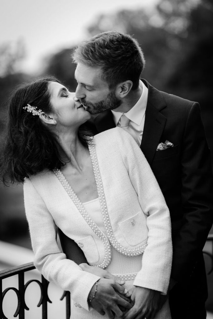 Black and white portrait of the bride and groom sharing an intimate moment during their wedding near Paris