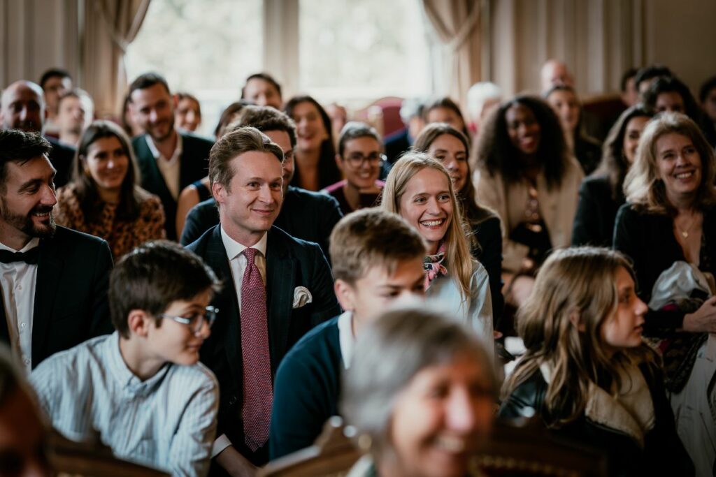 Wedding guests smiling during a city hall ceremony near Paris