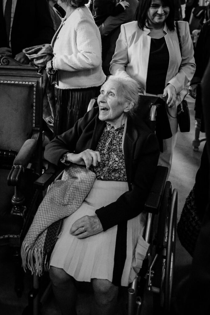 Emotional wedding guest smiling during the ceremony near Paris