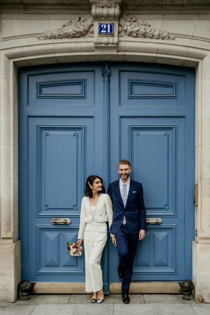 Modern wedding couple portrait in front of a blue Parisian door